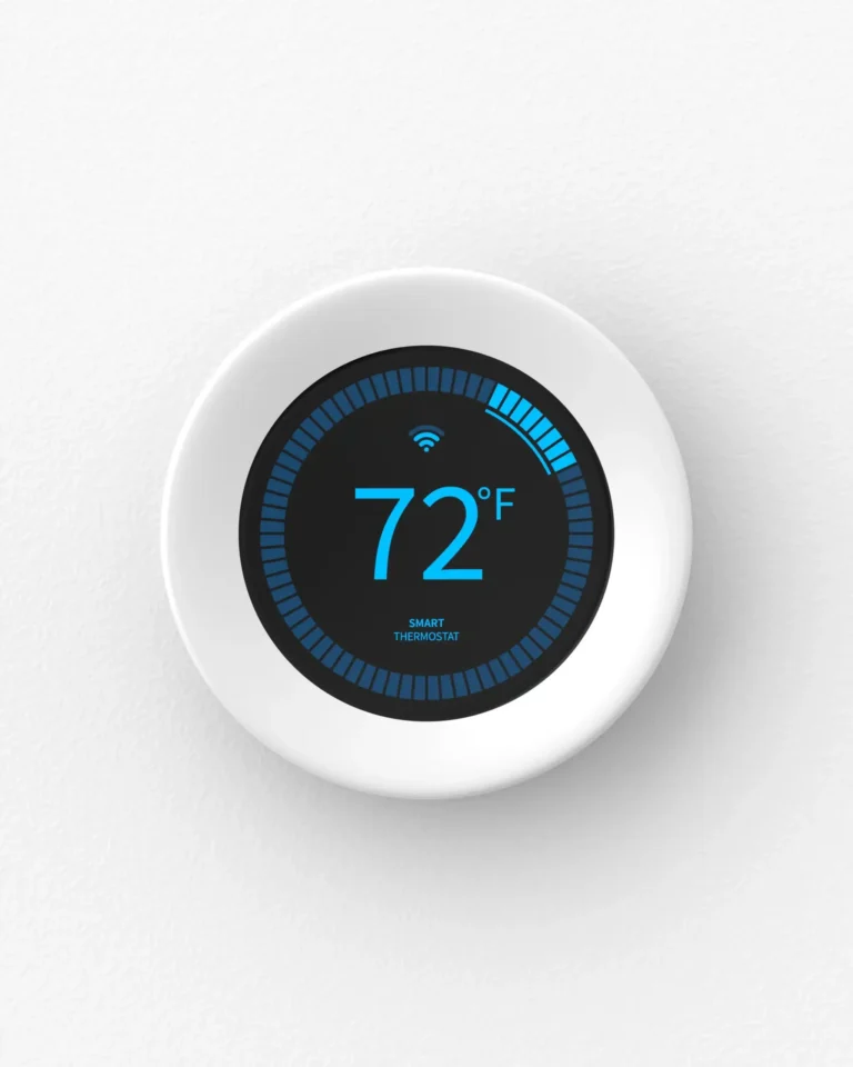 A smart thermostat displaying a temperature of 72°F on a circular, digital screen against a white wall.