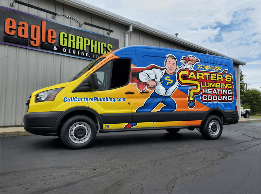 A brightly colored Carter’s Plumbing van, featuring a cartoon plumber character, is parked outside a building with an Eagle Graphics sign, highlighting their trusted plumbing services in southeastern MI.